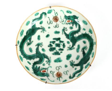 A pair of 19th Century Chinese saucer dishes, decorated with dragons and flaming pearls within shaped borders, one with red u