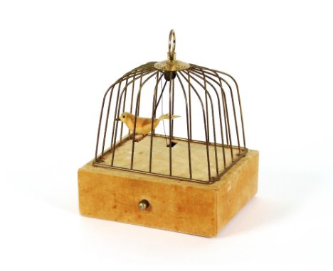 A 20th Century automaton, depicting a bird in a cage, the fabric covered base fitted with a single drawer, 20cm high x 19cm l