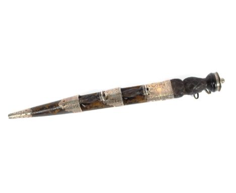 A Scottish Dirk, the white metal and leather cased&nbsp;scabbard containing a small knife and fork, 43cm long overall