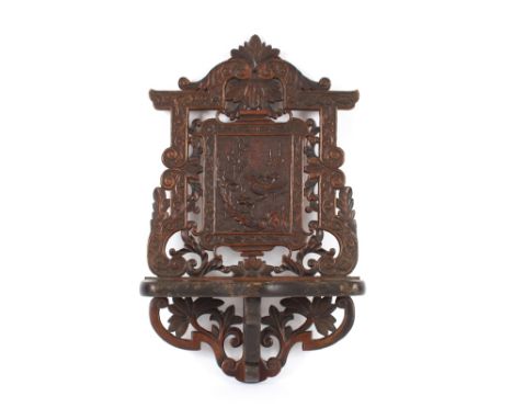 A Chinese carved hardwood wall shelf, profusely decorated with flowers and birds, 46cm x 30cm