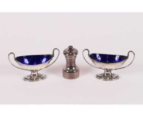 A pair of Sheffield plated salts, of oval pedestal form with blue glass liners; and a plated pepper mill