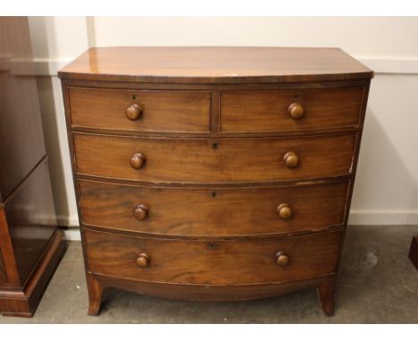 A 19th Century mahogany bow fronted chest, of two short and three long graduated drawers, raised on a shaped apron and bracke