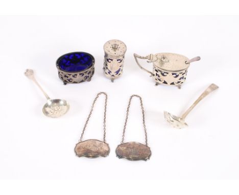 A small Edwardian three piece silver cruet, having foliate pierced sides and raised on scrolled feet, Birmingham 1906; two si