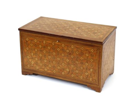 An Eastern inlaid trunk, decorated with stylised motifs and chequer-banding,89cm wide