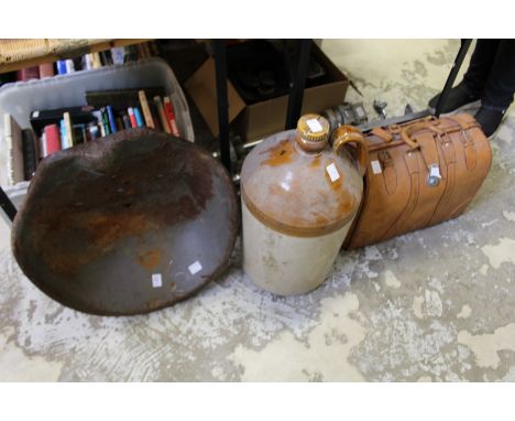 A metal tractor seat, together with a large flagon and a leather case.