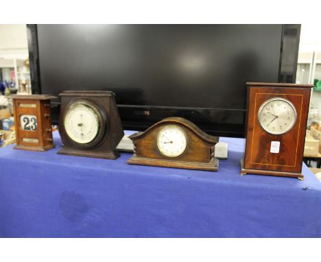 Two mantle clocks, a barometer and a desk calendar.