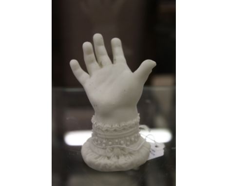 A small bisque porcelain model of a baby's hand.