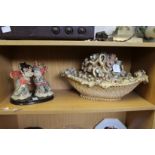 A model of two Chinese children and a moulded floral basket ornament.