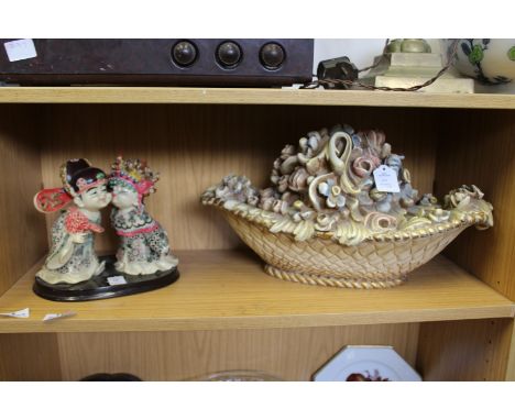 A model of two Chinese children and a moulded floral basket ornament.