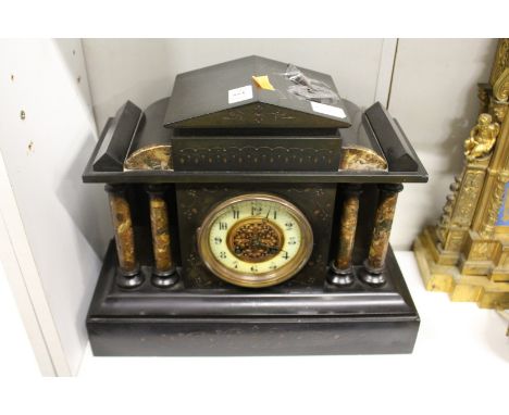 A Victorian black slate mantle clock.