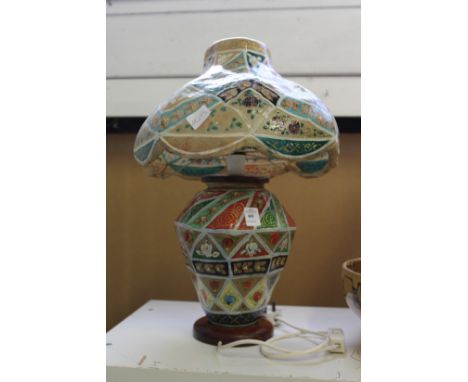 A decoratively painted vellum table lamp.