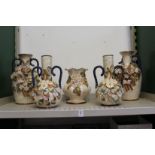 Decorative floral encrusted vases.