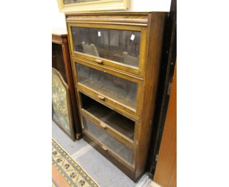 An oak Globe Wernicke style four section stacking bookcase (one section lacking glass).