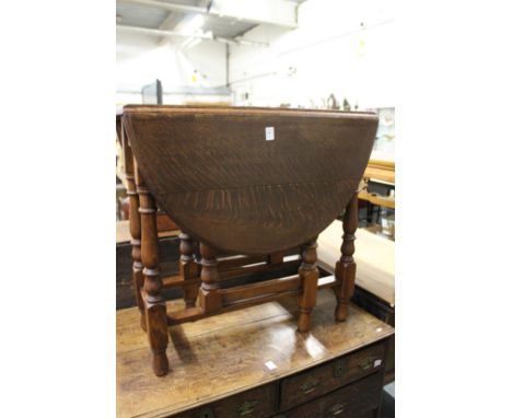 An oak drop leaf gate leg dining table.