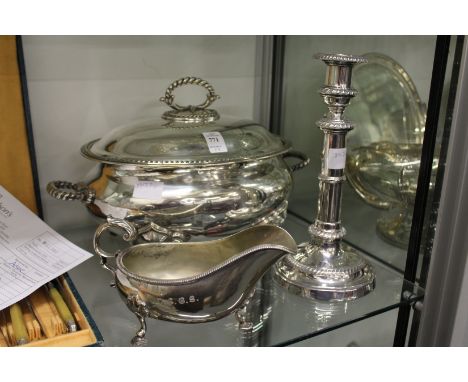 A plated tureen and cover, sauce boat and candlestick.