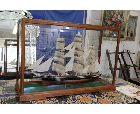 A very good large model sailing ship in a purpose built mahogany framed display cabinet, complete with original plans and boo