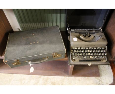 A leather writing case and an old typewriter.
