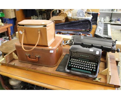 An old typewriter, sewing machine, projector and screen.