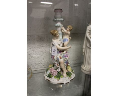 A continental porcelain figural candlestick group.