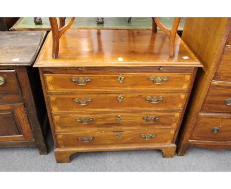 A 19th century mahogany and inlaid four drawer chest with brushing slide on bracket feet.
