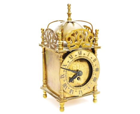 A mid 20thC Smiths brass lantern clock, with domed bell top, 1cm dia. Roman numeric chapter ring and shaped case revealing a 