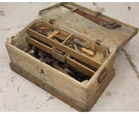 An early 20thC stripped pine tool box, of rectangular outline, 33cm H, 73cm W, 40cm D, containing a quantity of various hand 