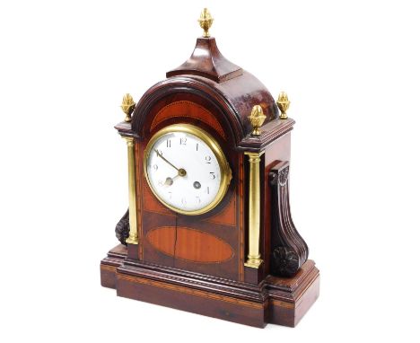 A 19thC mahogany satinwood and boxwood strung mantel clock, the domed case with five acorn finials housing a 10cm dia. enamel
