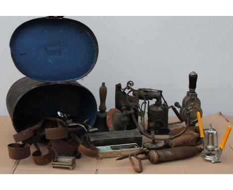 An early 20thC tin hat box, 35cm wide, with various other bygones, collectables, hand bell, blow lamps, hand sheep shears, sm