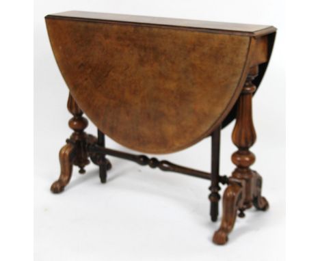 A Victorian walnut Sutherland table, the D-end top raised on heavy baluster columns, terminating in scroll feet, with a gate 