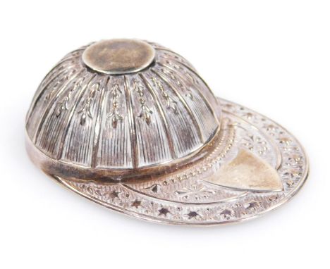 An Elizabeth II silver jockey's cap caddy spoon, with repoussé decorated stars and floral motif, Sheffield 1971, 5cm wide.