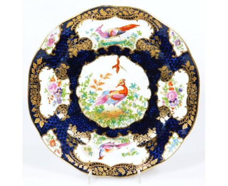 A Booths pottery plate, decorated with exotic birds within gilded cartouches on a blue scale ground, c.1900, unmarked, 23cm d