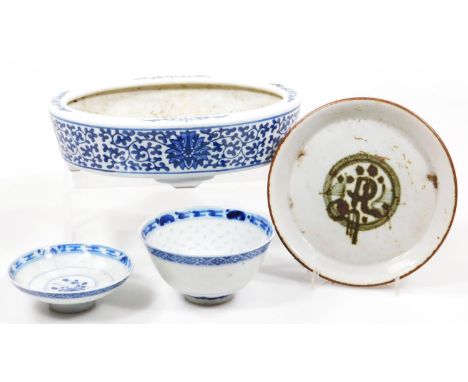 A Chinese porcelain dish, of oval outline, decorated with flowers and entwined stems, on shaped feet, Kangxi style seal mark,