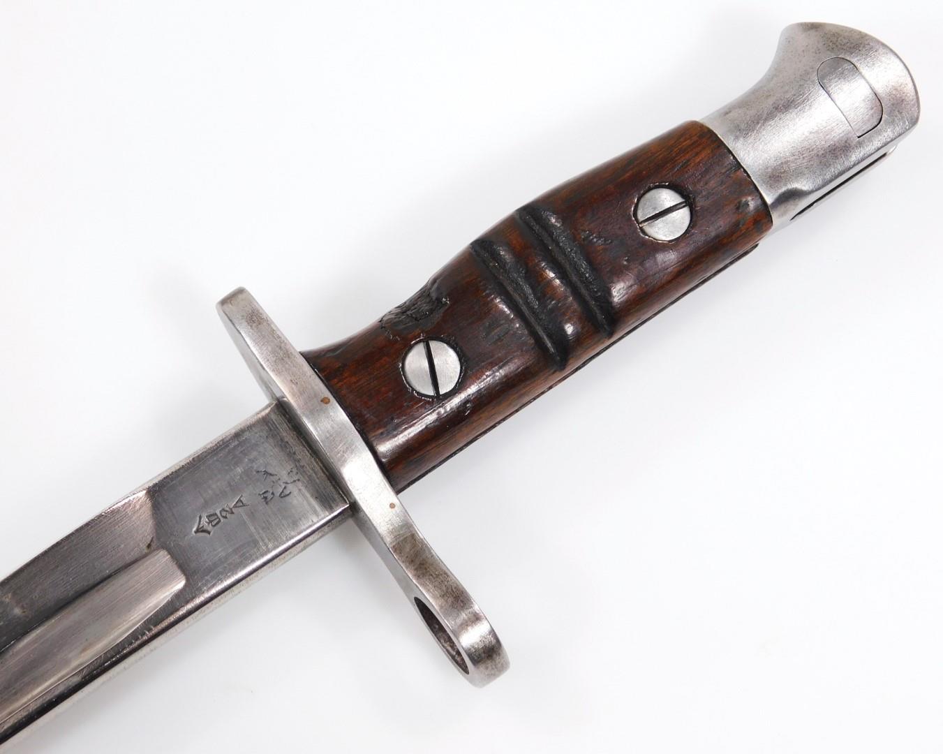 A 1913 pattern with wooden handle, polished metal end and