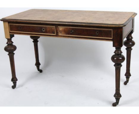 A 19thC walnut desk, the rounded top with a crossbanded burr wood inlay, raised on slender cylindrical supports set with two 