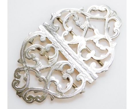 An early 20thC double buckle, of shaped outline with a pierced scroll and part engine turned centre, unmarked, 9cm wide.
