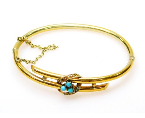A turquoise and seed pearl set bangle, of two row design, with floral centre, yellow metal, unmarked (AF), 6.2g all in. 