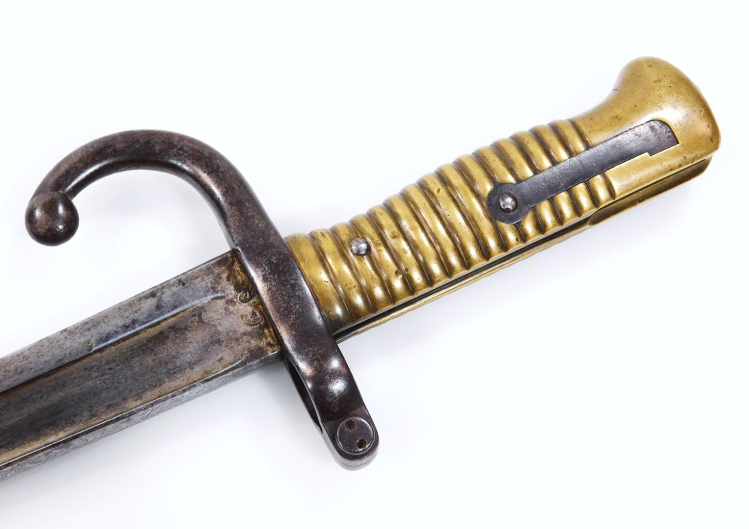 An 1869 pattern with turned brass handle, shaped named blade