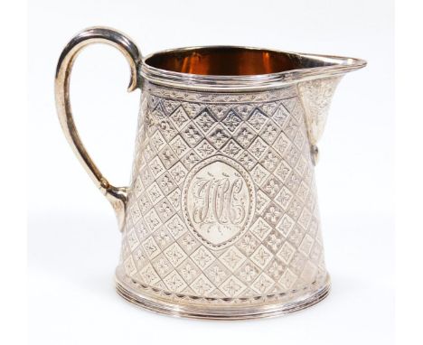A Victorian silver and silver gilt cream jug, with beak spout, C scroll handle and repeat engine turned floral body, with ova