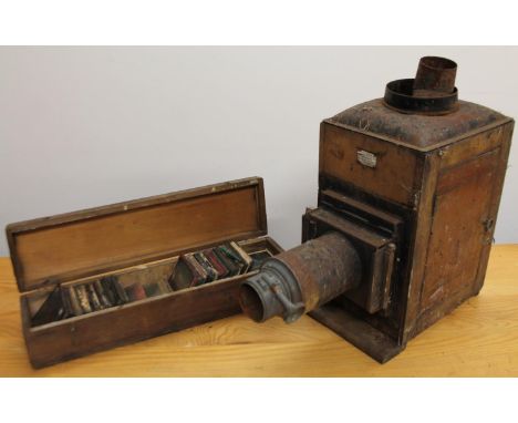 A late 19thC mahogany cased magic lantern projector, with metal mounts and Fleet Street label, 39cm high, various slides (a q