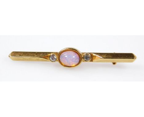 A bar brooch, set with opal type stone and two white paste stones, gold plated. 