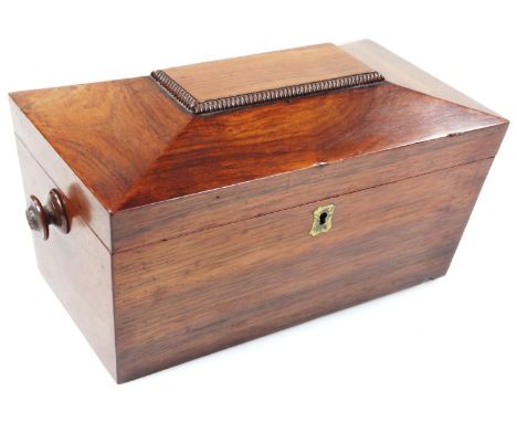 A Regency rosewood tea caddy, of sarcophagus outline, the hinged lid revealing a part fitted interior with space for mixing b