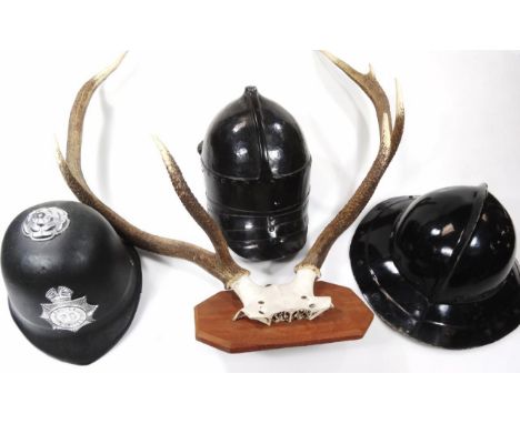 Various fibre glass war helmets, plastic police helmet, 20cm high, a pair of four point antlers. AUCTIONEER ANNOUNCE CAMERA E