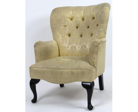 A Victorian button back occasional armchair, in (later) golden floral material, with a serpentine seat, on squat cabriole fro