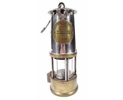 A mid 20thC Eccles 31 miner's lamp, in chrome and brass cylindrical case with central glass section and upper hook handle, la