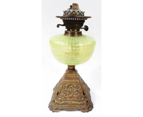 An early 20thC oil lamp, with metal top, green dot reservoir and metal part pierced base, 40cm high. 