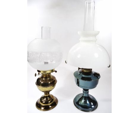An early 20thC brass oil lamp, with frosted and clear glass shade, plain funnel, and brass body, 51cm high, and another with 