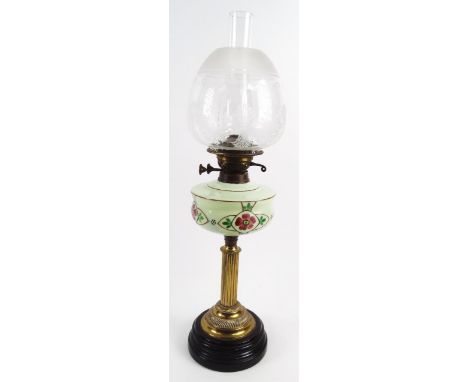 A late Victorian oil lamp, with clear funnel, frosted clear and etched glass shade, decorated with repeat shield on floral pa