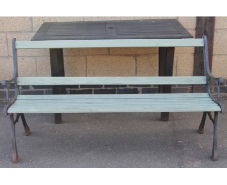 A slatted garden bench, partially painted green with metal ends. 79cm H, 144cm W, 56cm D and a teak garden table. (2)