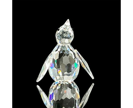 Standing penguin composed of an overall faceted crystal design. Finished with black beaded eyes. This item has its original b
