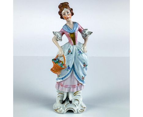 Ceramic figurine modeled as young maid carrying flower basket; blue, pink, and gold gilt details.Dresden Germany marked to ba